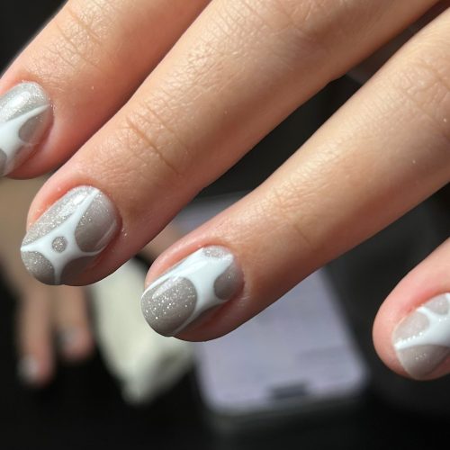 Manichiura gel gri sidefat cu modele albe abstracte si glitter